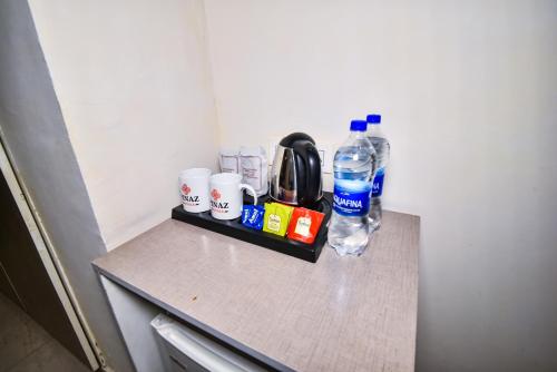 a counter with a bottle of water and other items on it at Pinaz Royale in Amritsar