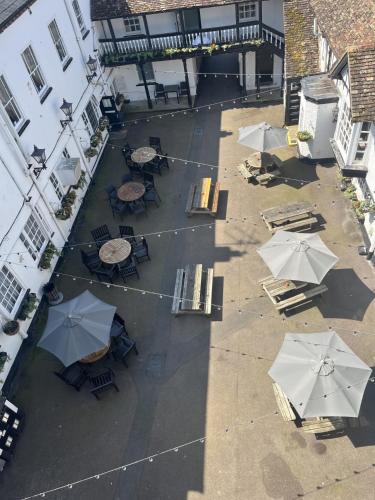an overhead view of a patio with tables and umbrellas at George Hotel by Greene King Inns in Huntingdon
