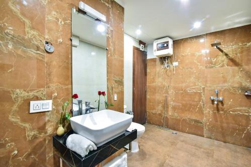 a bathroom with a sink and a toilet and a shower at Pinaz Royale in Amritsar
