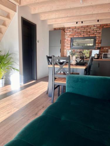a living room with a couch and a table with chairs at DOMIKO in Nickelswalde