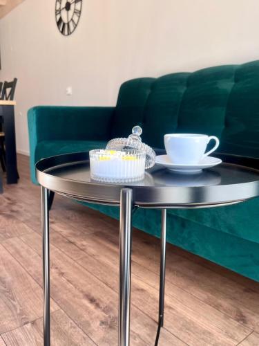 a black coffee table with a cup of coffee on top at DOMIKO in Nickelswalde