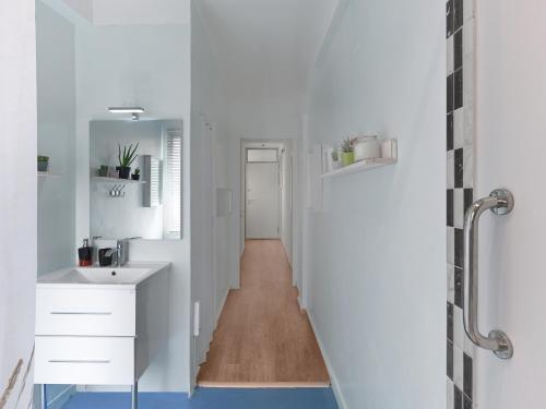 a bathroom with white counters and a long hallway at Luxurious Top Floor Acropolis View Loft in Plaka - Newly Refurbished in Athens