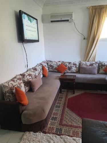 a living room with a couch and a flat screen tv at Marrakech in Marrakech