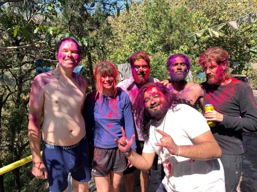a group of people covered in paint posing for a picture at Clan Boho in Rishīkesh