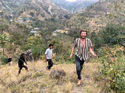 a group of men walking in a field at Clan Boho in Rishīkesh
