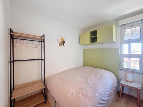 - une petite chambre avec un lit et une étagère dans l'établissement V-Landes 06-Vieux Boucau appartement 6 personnes dans résidence avec piscine face au lac marin, à Vieux-Boucau-les-Bains