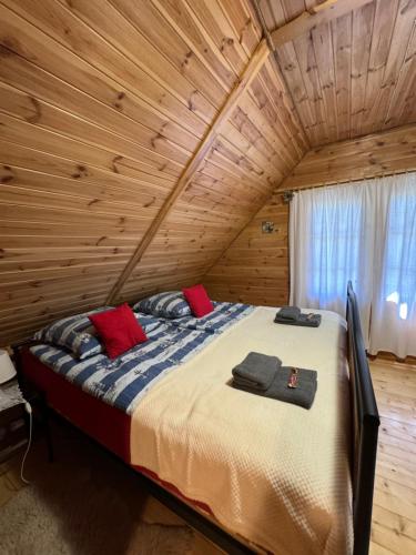 ein Schlafzimmer mit einem Bett in einem Blockhaus in der Unterkunft Domek Borsk in Borsk