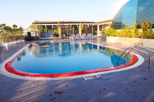 a large swimming pool in the middle of a building at Fortune Grand Hotel in Dubai