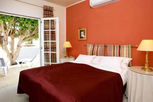 En eller flere senge i et værelse på Casa Karen