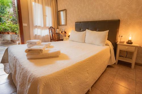 a bedroom with a bed with two towels on it at La Asomada del Gato in La Laguna