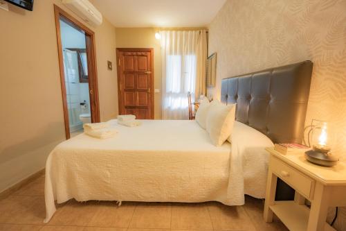 a bedroom with a large bed and a table at La Asomada del Gato in La Laguna