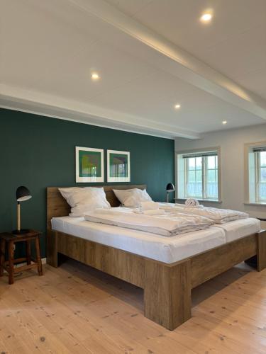 a large bedroom with a large bed in a room at Hygge Ho - mitten in der Natur mit Sauna und Spa in Blåvand