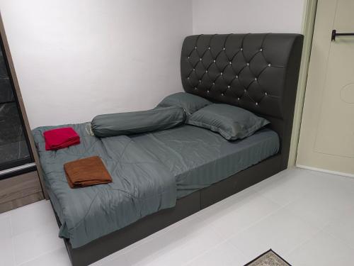 a bed with a headboard in a room at ROOMSTAY NIMAZA Bilik 1 in Marang