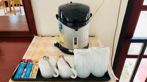 a juicer sitting on a table next to white shoes at Suan Bankrut Beach Resort in Ban Krut