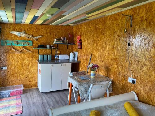 a kitchen with a table and a small kitchen with a counter at Sunrise Cabin in Carbis Bay