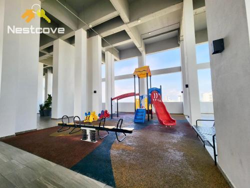 a large room with a playground with a slide at The Quartz Residence & Suites Infinity Pool By Nestcove in Melaka