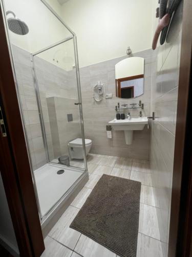 a bathroom with a shower and a toilet and a sink at Apartament centrum in Warsaw