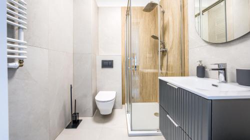 隱海市的住宿－Apartamenty Sun & Snow Słoneczne，浴室配有卫生间、盥洗盆和淋浴。