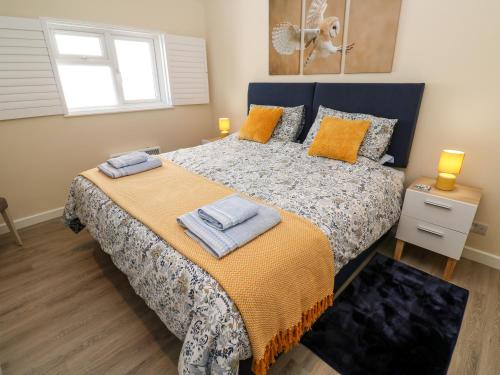 a bedroom with a bed with towels on it at Chy-An-Oula in Falmouth