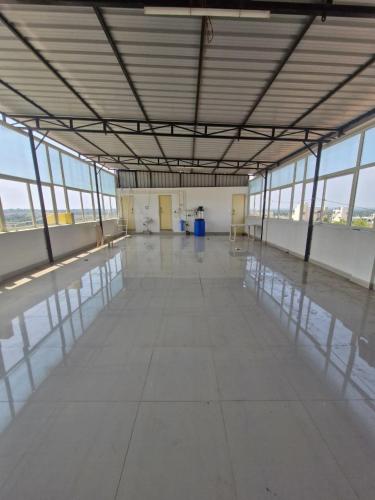 an empty building with a large room with windows at MITRA Hotels & Retreat in Mysore