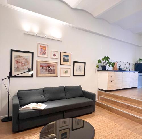 a living room with a couch and a table at Aumetz square apartment in Idrija