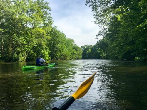 a man in a kayak on a river with a paddle at Loup Castel Boutique Hotel B&B in Le Bar-sur-Loup