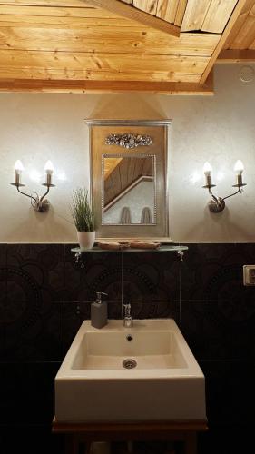 a bathroom with a sink and a mirror on the wall at Jaunsētas in Alūksne