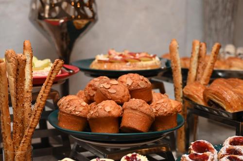a table with plates of pastries and other desserts at Mysk Al Balad in Al Madinah