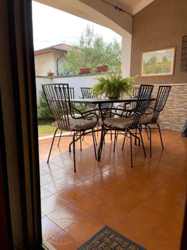 a patio with a table with chairs and a plant at La casa di Morena in Torre del Lago Puccini