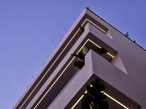 a large white cross on the side of a building at Bond Smart Living Suites in Athens