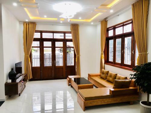 a living room with a couch and a table at NHỚ House IV in Da Lat