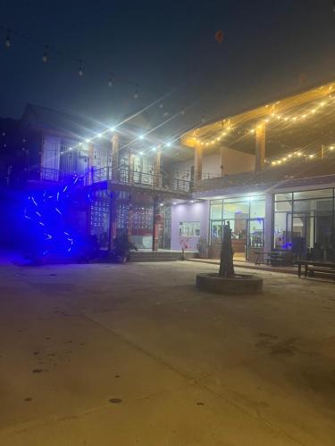 an empty parking lot in front of a building at night at Kala view homestay in Di Linh