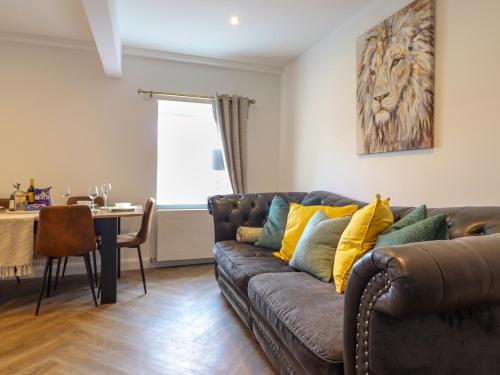 a living room with a couch and a table at Trysorau Bach 2 in Llanrwst