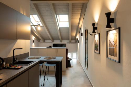 a kitchen with a counter and a island in a room at Palais Bernadette in Parma