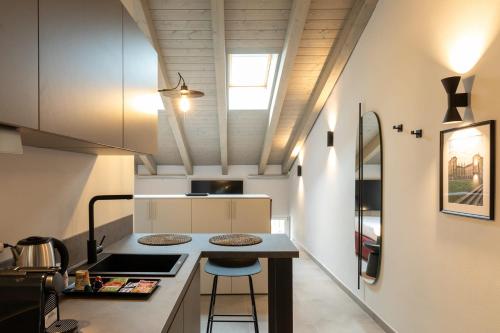 a small kitchen with a counter and a table at Palais Bernadette in Parma