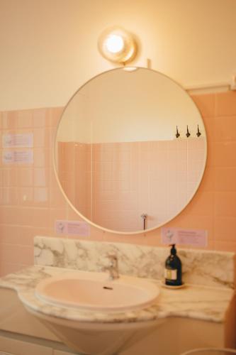 a bathroom with a sink and a mirror at Cozy Garden Rooms in Chevilly-Larue