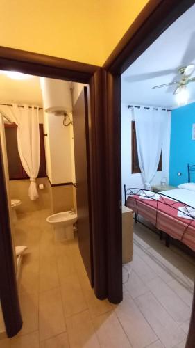 a view of a room with two beds and a bathroom at Sa Jaga Brujada Residence - Simar Vacanze in Porto Rotondo