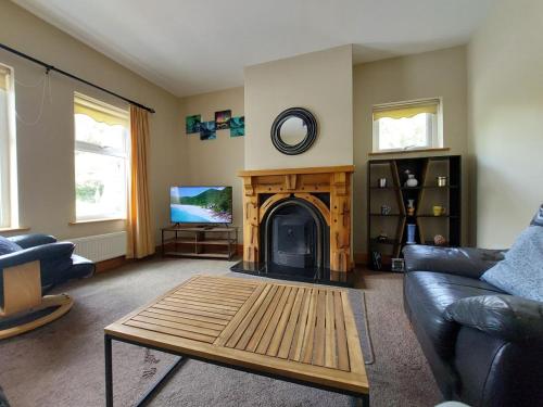 a living room with a fireplace and a couch at Home in Ennis in Ennis