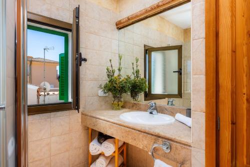 a bathroom with a sink and a mirror at Ran de Mar in Son Serra de Marina