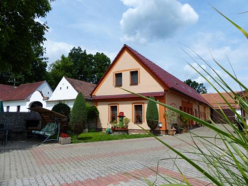 a yellow house with a red roof at Penzion Říše in Třeboň