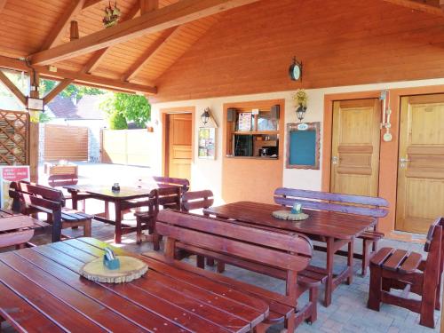 an outdoor patio with wooden tables and benches at Penzion Říše in Třeboň