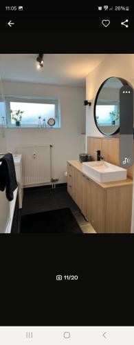 a bathroom with a sink and a mirror at NJoy Apartments in Nürnberg