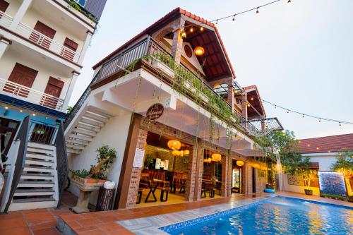 a house with a swimming pool in front of a building at Gia Nguyen Hotel in Ninh Binh