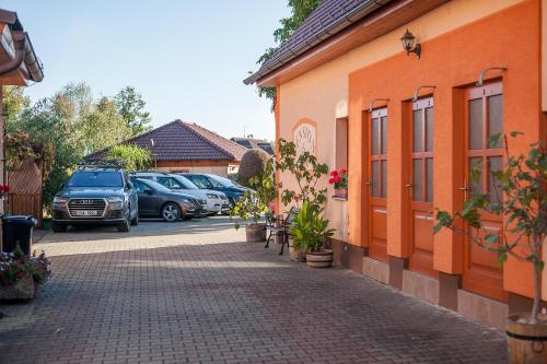 a street with cars parked next to a building at Penzion Říše in Třeboň