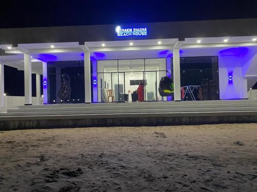 a building with purple lights on the front of it at Shakin Shasha Beach House/neithalbeachcity in Jaffna