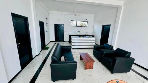 a living room with two chairs and a table at Shakin Shasha Beach House/neithalbeachcity in Jaffna