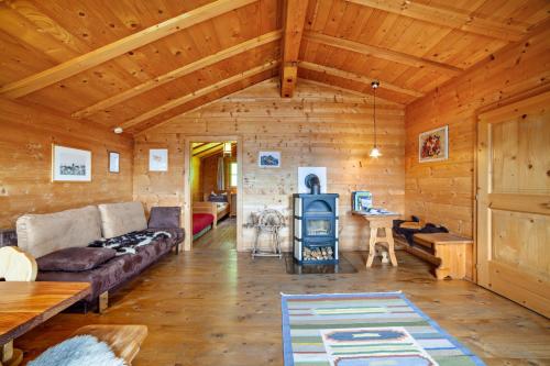 a living room with a couch and a table at Ferienhaus Rauchegg - Bergblick in San Pancrazio dʼUltimo
