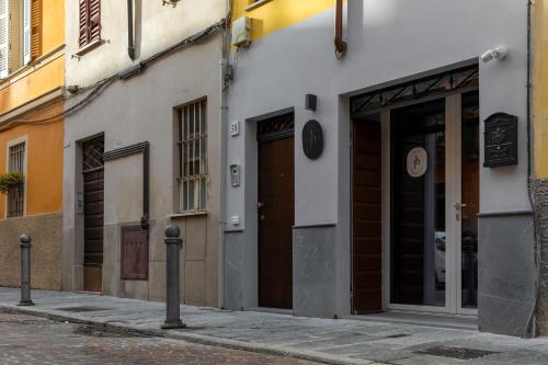 a building with two doors on a street at Palais Bernadette in Parma