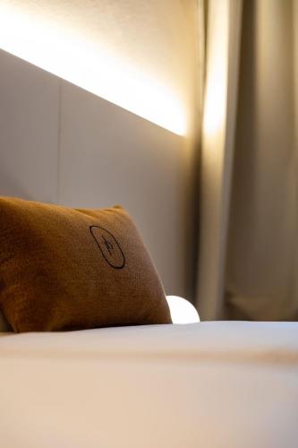 a pillow sitting on top of a bed at Palais Bernadette in Parma