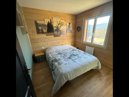 a bedroom with a bed in a room with a window at La Granja - Maison avec cheminée, jardin, baby-foot in Formiguères